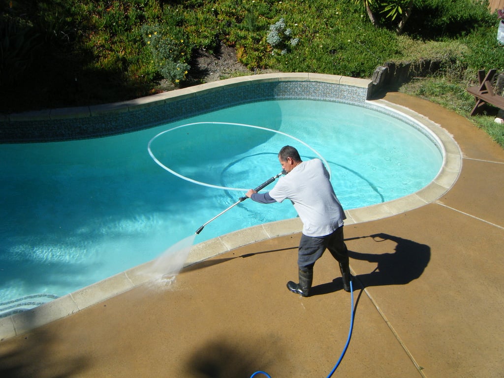 cleaning the pool the advantages of having a pressure washer